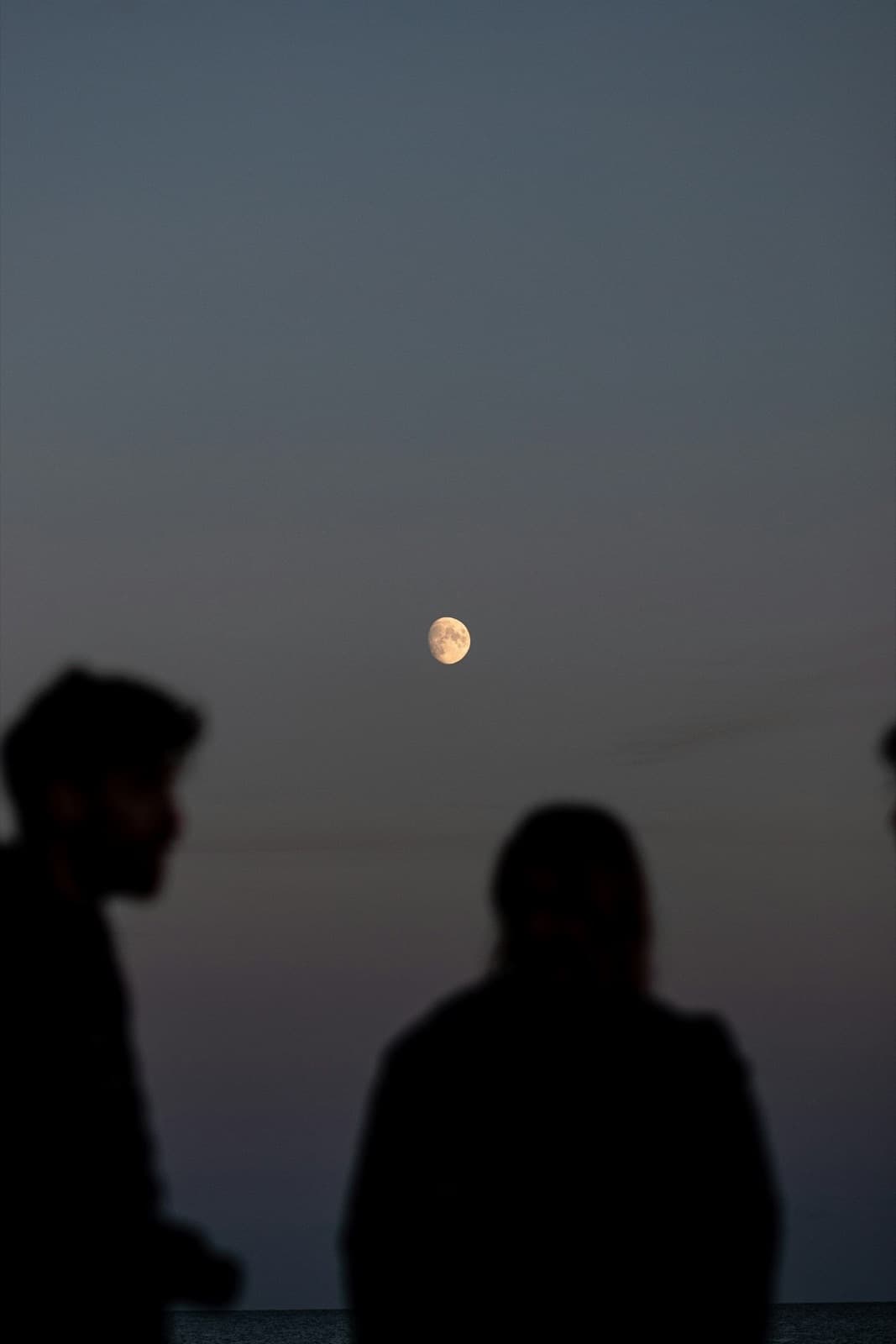 Two people sitting together under an evening sky — reconnecting through couples therapy