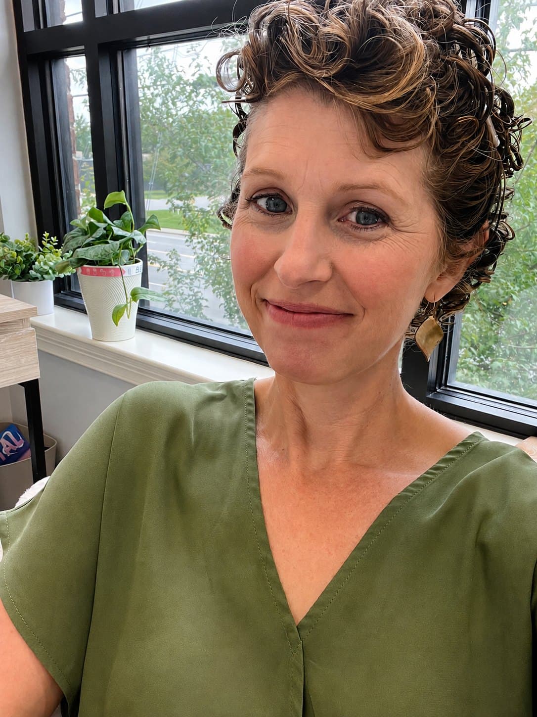 Jennifer Bartley in her Mt. Juliet office, beside a window with plants on the sill