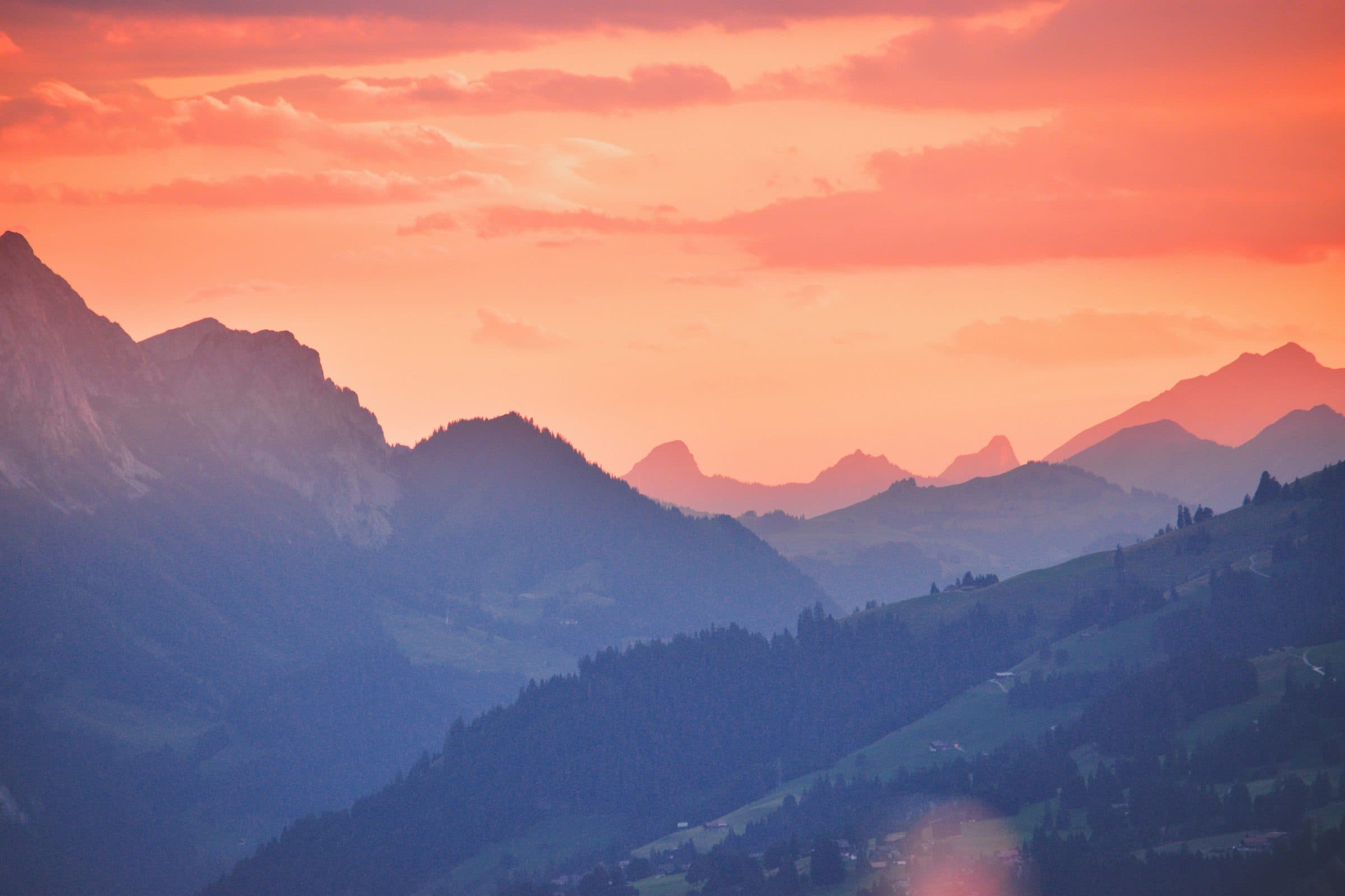 Pink dawn light over a distant mountain range
