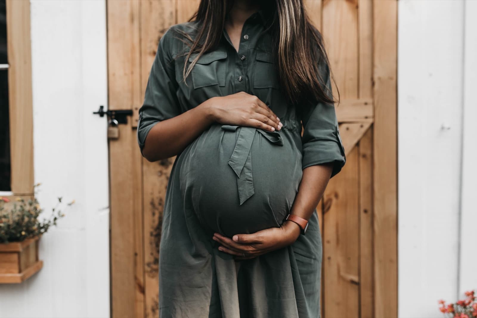 An expecting parent cradling their belly — pregnancy and postpartum therapy in Nashville, TN